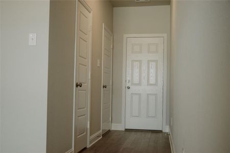 Hallway with dark hardwood / wood-style flooring