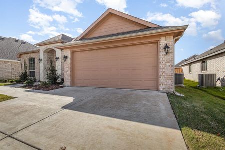 Ranch-style house with central AC, a front lawn, and a garage