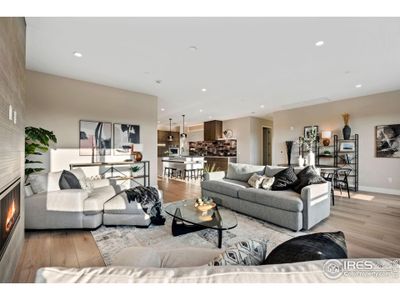 A HUGE combined living/dining space looks right out to the Rocky Mountains, above rooftops.