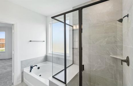 Spacious owner's bathroom with oversized shower*real home pictured