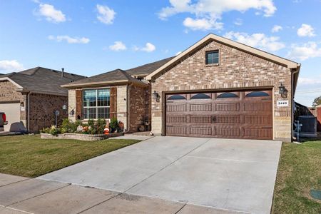 Ranch-style house featuring a garage, a front lawn, and cooling unit