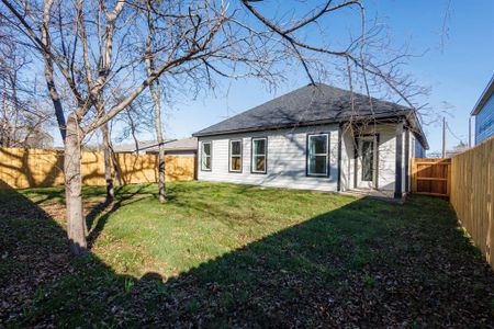 Rear view of property with a lawn