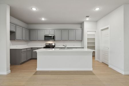 Kitchen in the Oscar home plan by Trophy Signature Homes – REPRESENTATIVE PHOTO