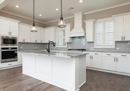 Beautiful light fixtures hang over the kitchen island.