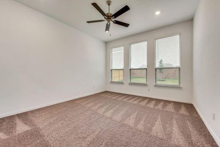 Empty room featuring carpet flooring and ceiling fan