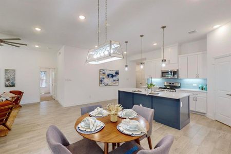 Dining space featuring ceiling fan and light hardwood / wood-style flooring