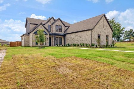 Tudor-style house with a front yard