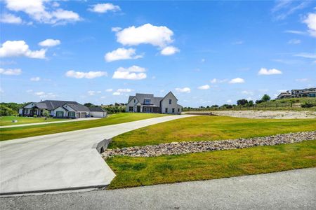 View of nearby features with a garage and a lawn