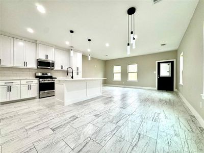 Large open concept living and dining room off of kitchen.