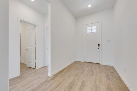 Foyer with light hardwood / wood-style floors