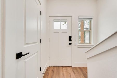 Foyer with light hardwood / wood-style floors