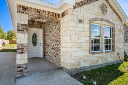 Covered entrance with custom front door.