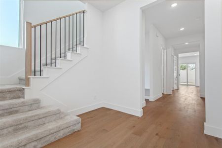 Staircase featuring hardwood / wood-style flooring