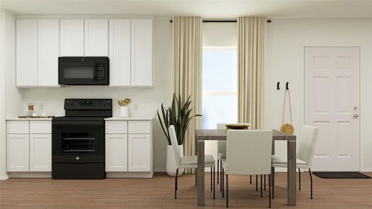 Kitchen featuring light wood-type flooring, white cabinetry, and black appliances