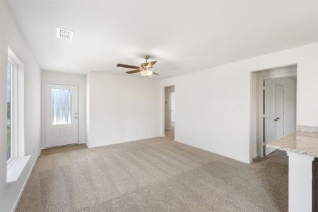 Living room with carpet and ceiling fan