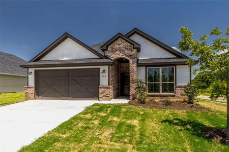 View of front of house with a garage and a front yard