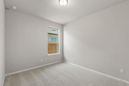 Your secondary bedroom features plush carpet, fresh paint, closet, and a large window that lets in plenty of natural lighting.