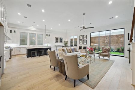 The living room opens to the kitchen and 10' sliding stacking doors to your private fenced-in back yard