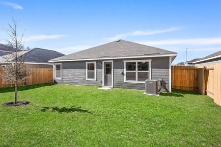 Back of property with central air condition unit and a lawn