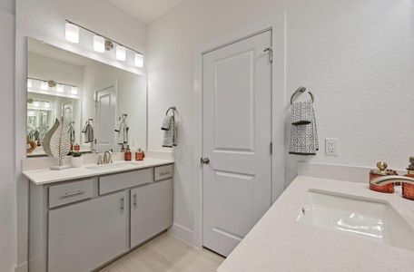 Bathroom with tile patterned floors and vanity