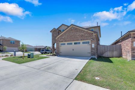 View of home's exterior with a lawn, concrete driveway, a garage, and brick siding View of home's exterior with a lawn, concrete driveway, a garage, and brick siding