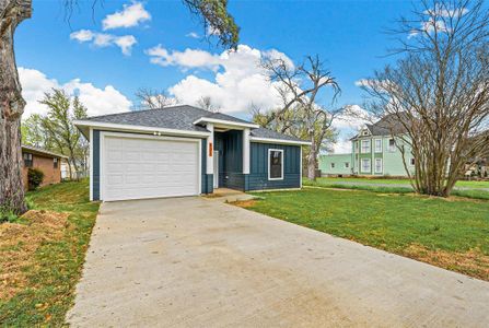 View of front of home with a garage and a front yard