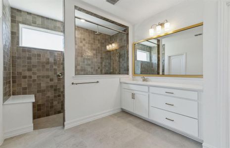 Spacious owner's bathroom with dual vanity and oversized shower *real home pictured