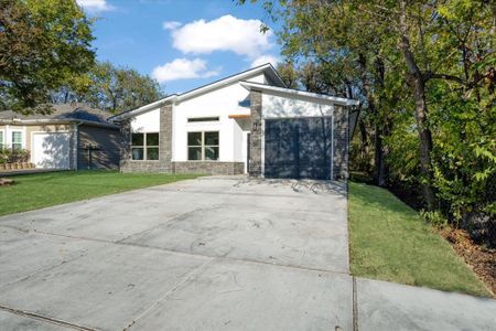 View of front of home featuring a front yard and a garage