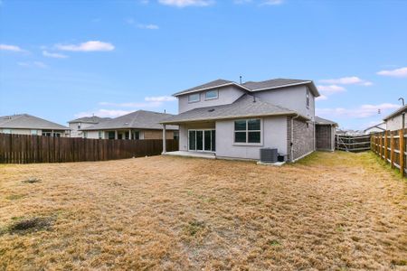 Rear view of house featuring a patio, a fenced backyard, cooling unit, a lawn, and stucco siding