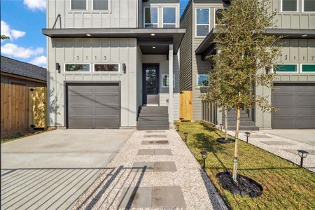 A closer look of all the detail from landscaping to concrete pavered walkway with flagstone that allows for additional parking that does not block the garage to accomodate the tandem parking.