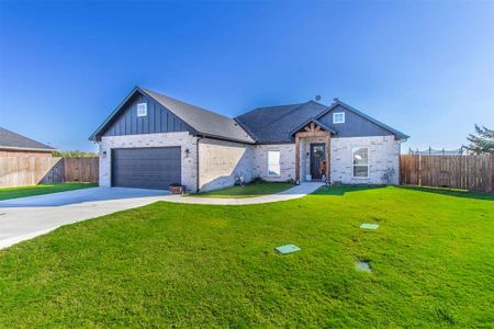 View of front of property with a garage and a front yard