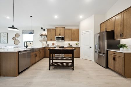 Kitchen with pendant lighting and chrome hardware