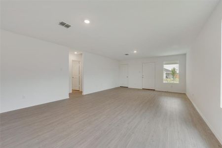 Empty room with light hardwood / wood-style floors