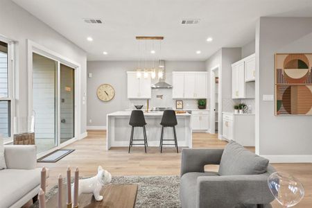 Living room featuring a chandelier and light wood-type flooring