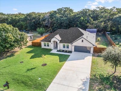 View of front of home with a garage and a front lawn