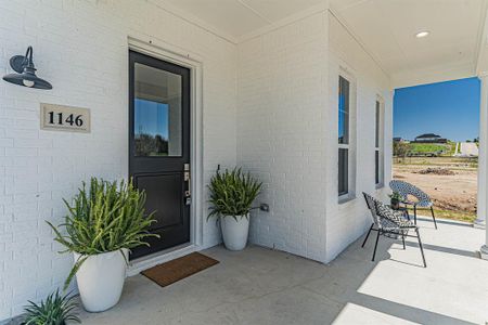 Doorway to property featuring a porch