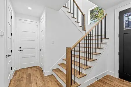 Stairway featuring wood-type flooring