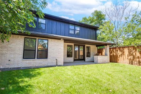 Back of house featuring a patio area and a lawn