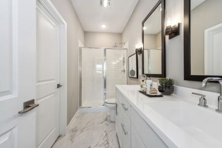 Primary suite bathroom with matte chrome fixtures and hardware