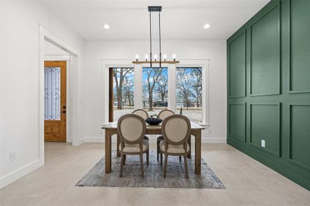 Dining area featuring recessed lighting, a notable chandelier, and baseboards