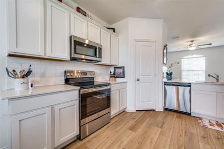 Kitchen opens to the living area and has a breakfast bar.