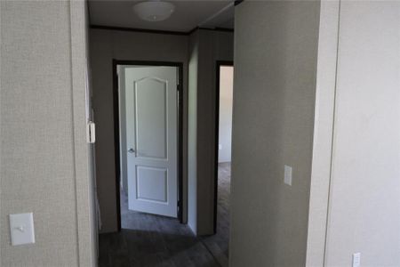 Corridor with dark hardwood / wood-style floors