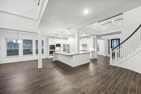 Experience the seamless flow of this large open kitchen, perfectly positioned to overlook the cozy breakfast room and inviting family room. Natural light floods the space, enhancing the warm ambiance and creating an ideal setting for family gatherings and casual dining.