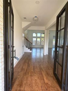 Entryway with french doors and hardwood / wood-style floors