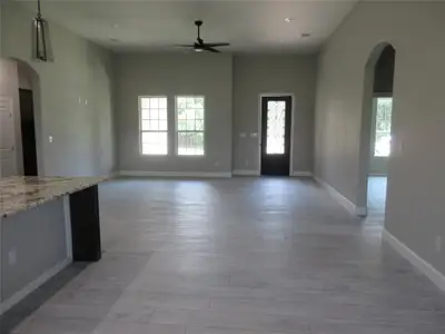 Unfurnished living room featuring light hardwood / wood-style flooring and a wealth of natural light