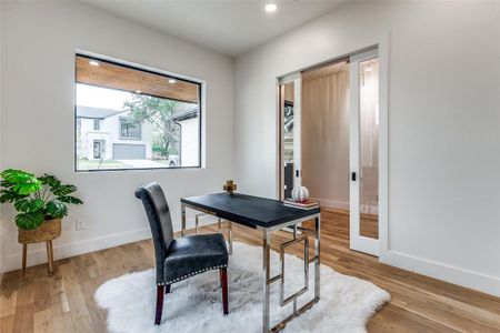 Office area with light hardwood / wood-style floors