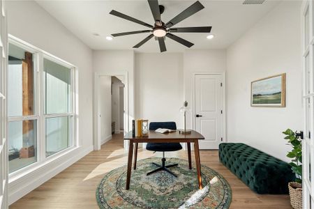 Home office with ceiling fan and light wood-type flooring