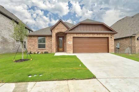 View of front of house with a front yard and a garage