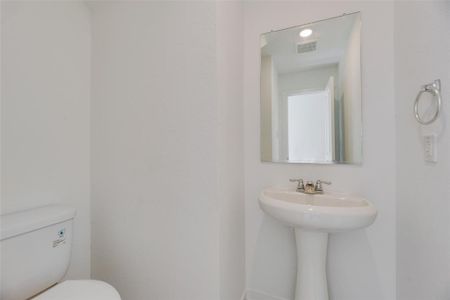 Bathroom featuring sink and toilet