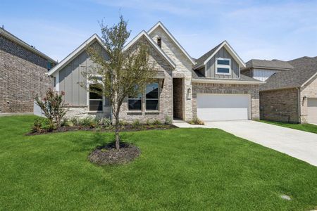 View of front of home with a garage and a front yard